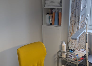Bright yellow chair and organized nail supplies at Agi Nails, Bulwark, Wales, GB.