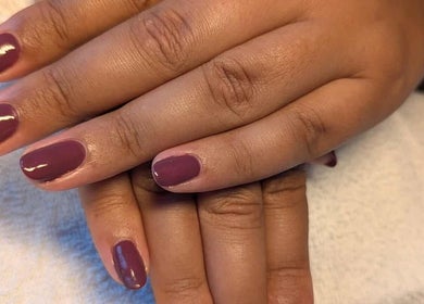 Elegant purple manicure from Agi Nails, Bulwark, Wales, GB, showcasing glossy finish on well-groomed nails.