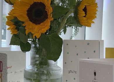 Sunflowers and greeting cards at Studio555, Clydebank, Scotland, GB create a welcoming ambiance.