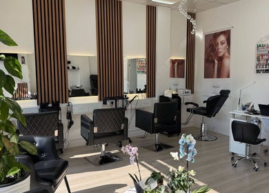 Sophisticated salon interior at ZS Hair & Beauty, Welling, England, GB, featuring stylish chairs and mirrors.