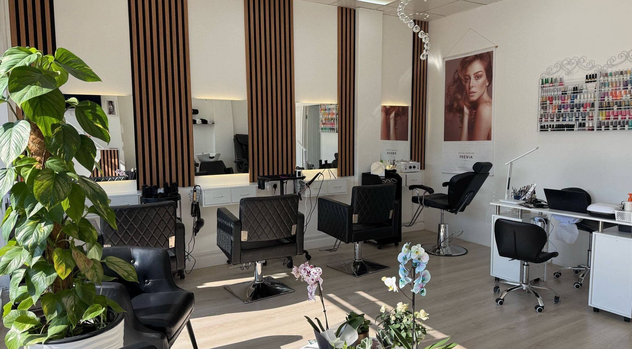 Sophisticated salon interior at ZS Hair & Beauty, Welling, England, GB, featuring stylish chairs and mirrors.