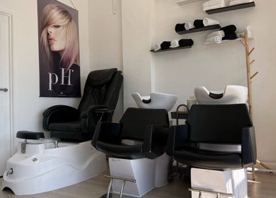 Modern salon chairs and wash basins at ZS Hair & Beauty, Welling, England, GB. Sleek and inviting ambiance.