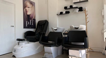 Modern salon chairs and wash basins at ZS Hair & Beauty, Welling, England, GB. Sleek and inviting ambiance.