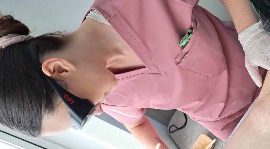 Professional providing laser treatment at Illuminate Mobile Clinic in Bramley, England, GB.