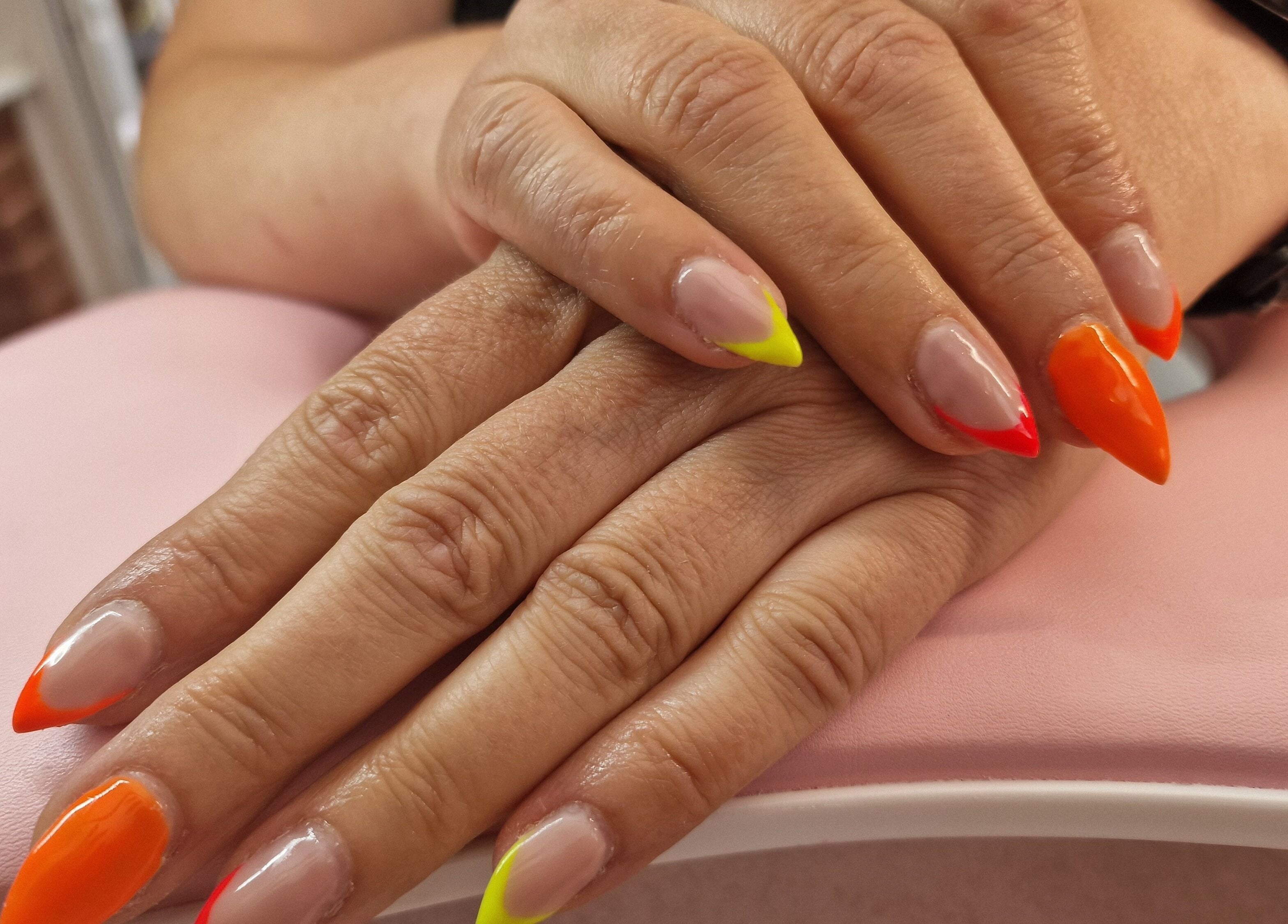 Vibrant nail art at Glamour Nails Telford, showcasing bright colors on a pink backdrop in Telford, England, GB.