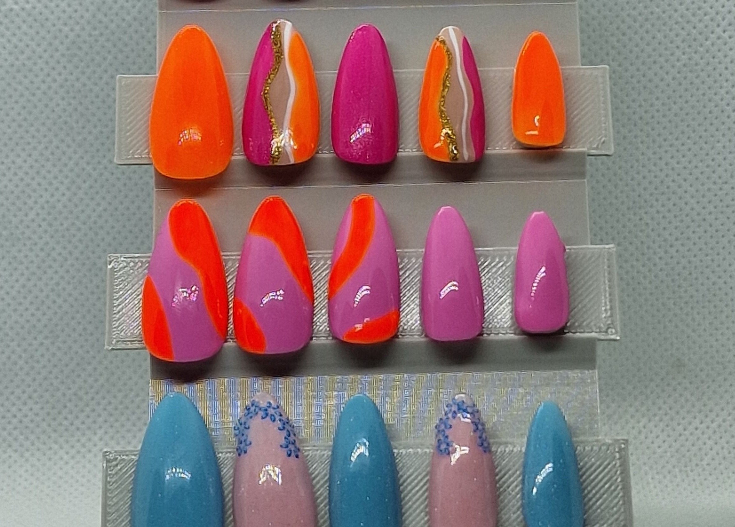 Colorful nail art samples at Glamour Nails Telford, showcasing vibrant styles in Telford, England, GB.