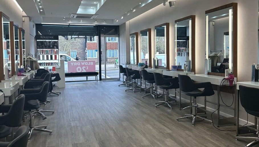 Interior of HAIR COLLECTIVE in London, England, GB featuring modern styling stations and sleek design.