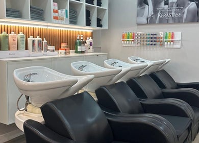 Modern hair wash stations at HAIR COLLECTIVE, London, England, GB, with premium products displayed.