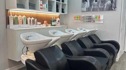 Modern hair wash stations at HAIR COLLECTIVE, London, England, GB, with premium products displayed.