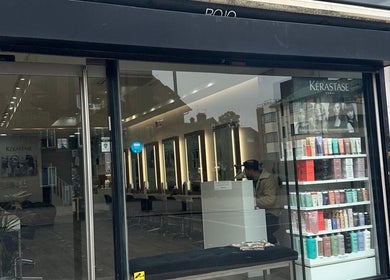 Exterior view of HAIR COLLECTIVE salon in London, England, GB showcasing modern interior and product display.