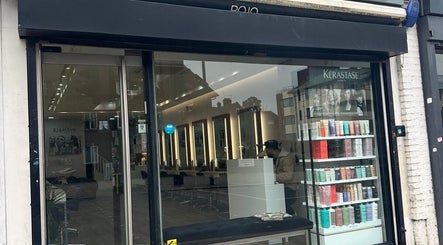 Exterior view of HAIR COLLECTIVE salon in London, England, GB showcasing modern interior and product display.