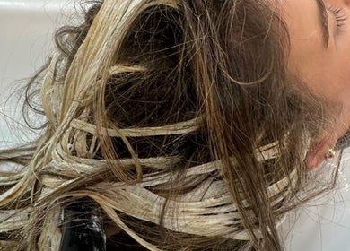Hair highlights in progress at HAIR COLLECTIVE, London, England, GB. Blonde highlights for a fresh look.