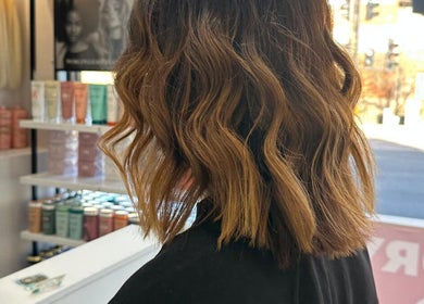 Stylish wavy hairstyle at HAIR COLLECTIVE, London, England, GB, showcasing premium hair products.