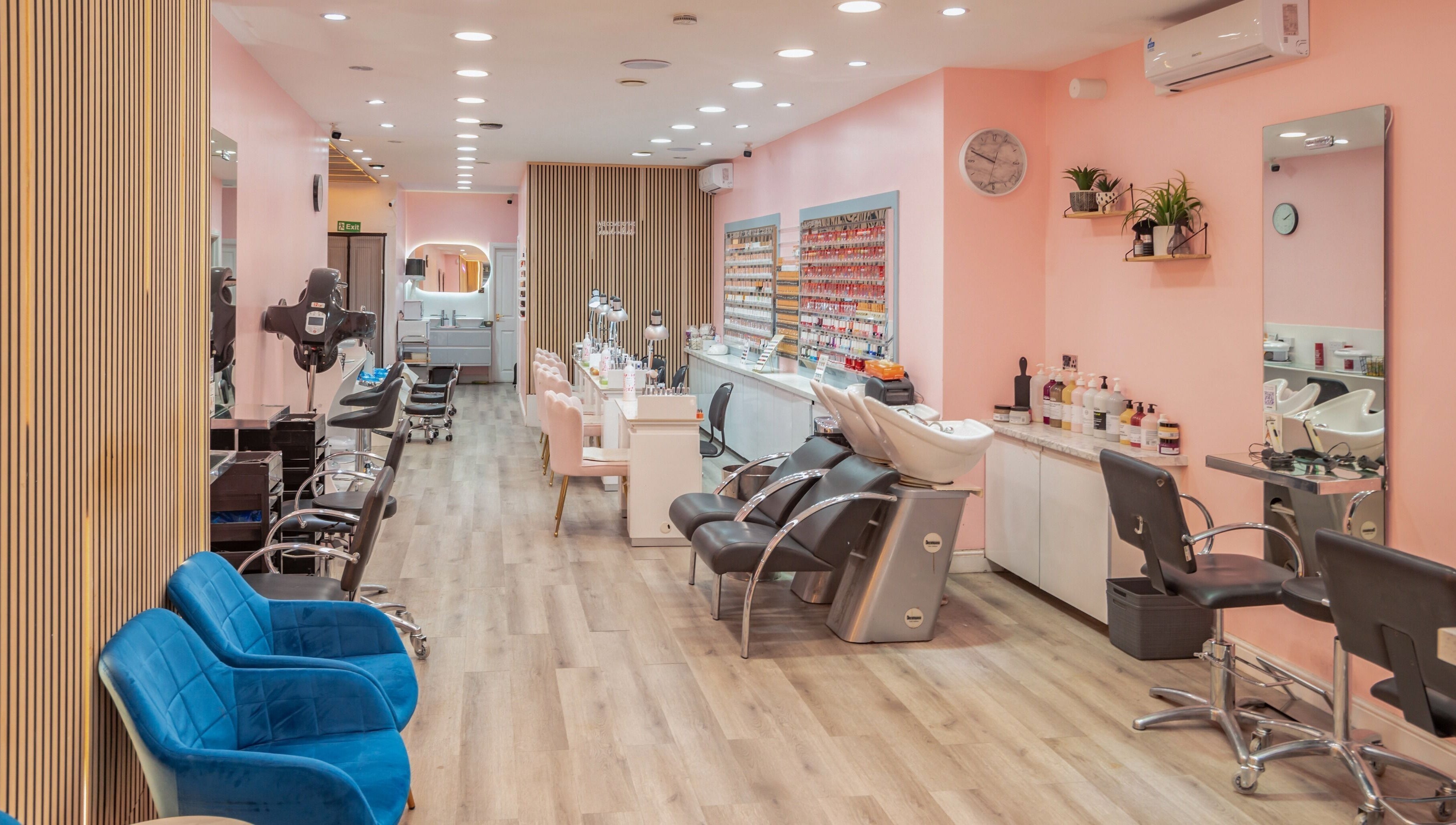Elegant salon interior at Candy Wanstead, London, England, GB with plush seating and modern styling stations.