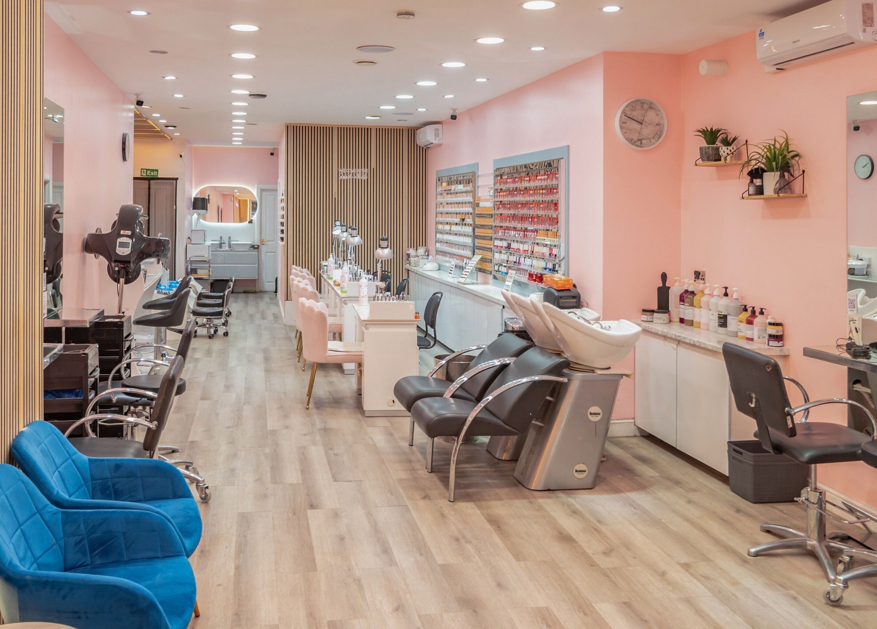 Elegant salon interior at Candy Wanstead, London, England, GB with plush seating and modern styling stations.