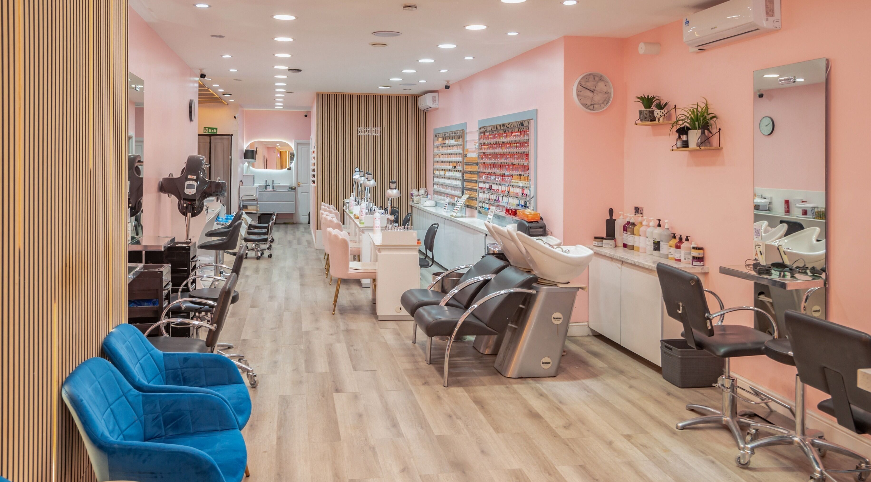 Elegant salon interior at Candy Wanstead, London, England, GB with plush seating and modern styling stations.