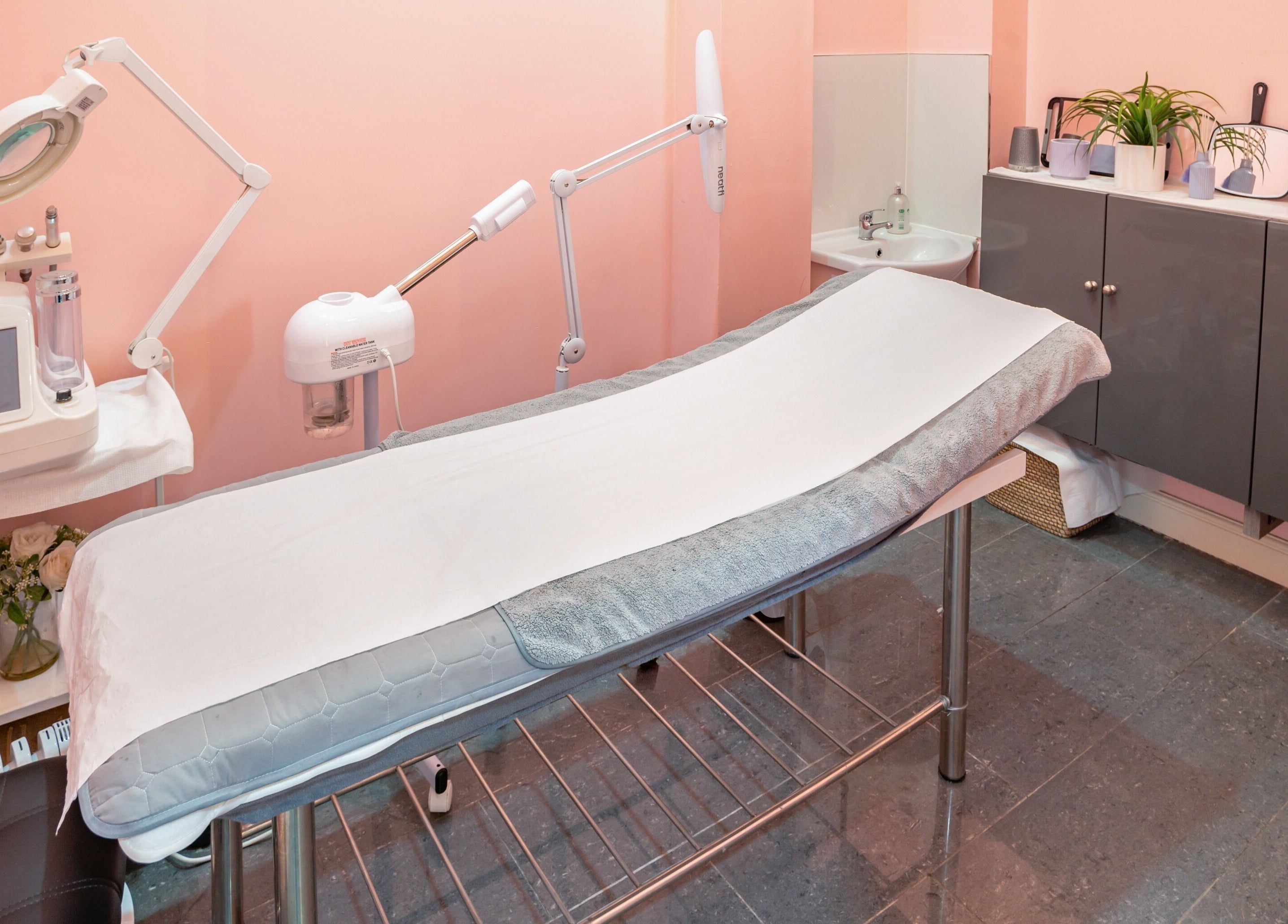 Relaxing treatment room at Candy Wanstead, London, England. Sleek design with modern equipment for a serene experience.