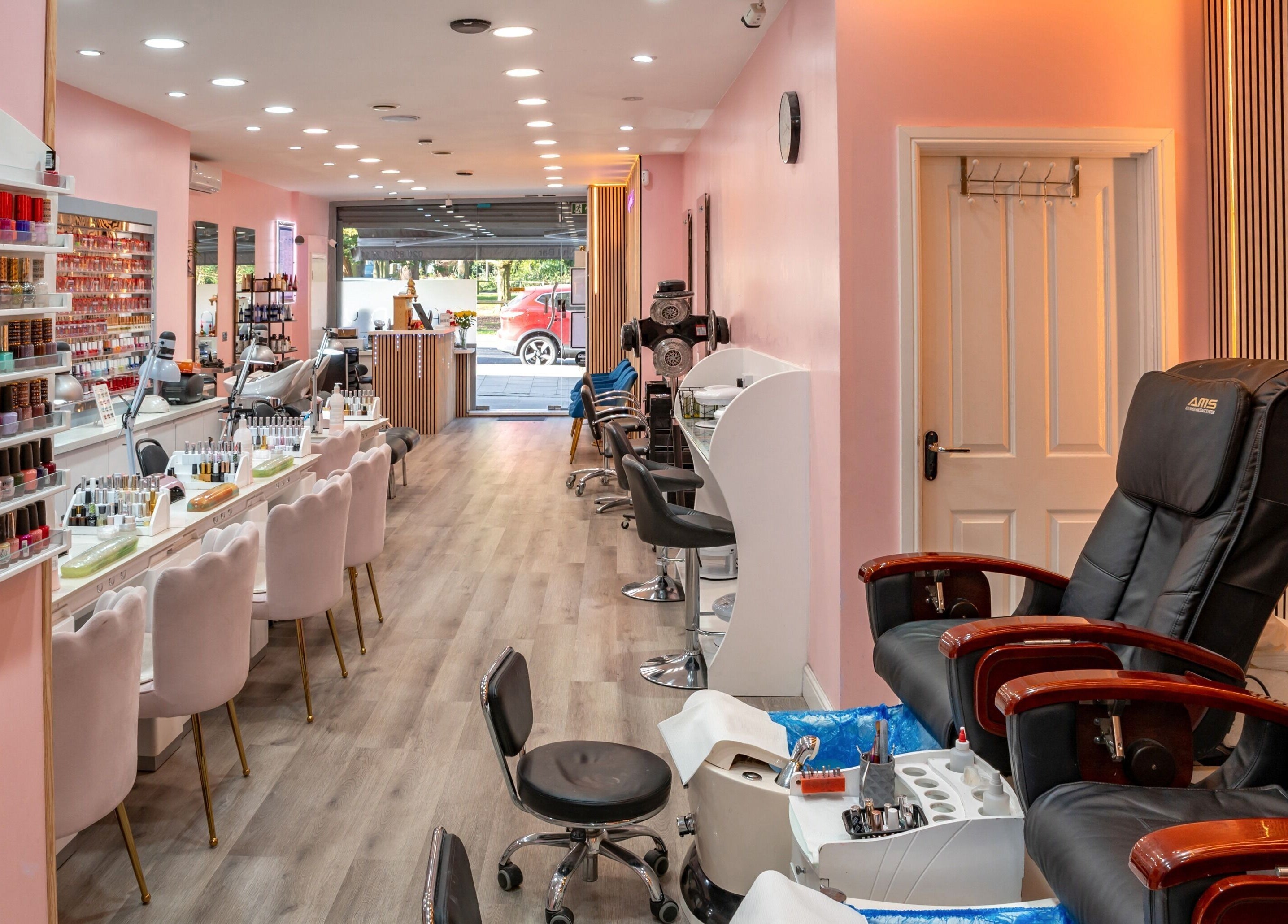Candy Wanstead's elegant nail salon interior in London, England, GB showcasing chairs and polish display.