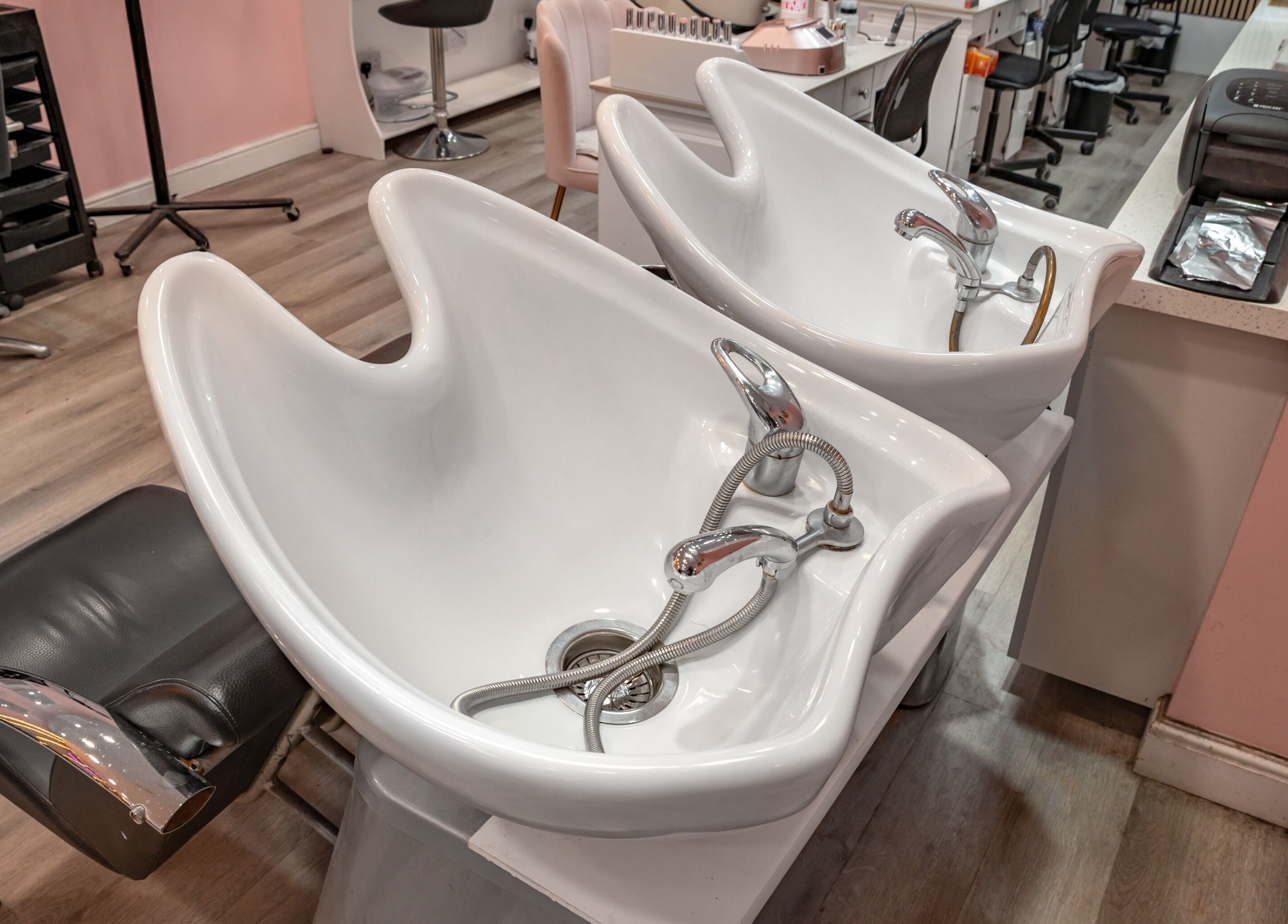 Modern hair wash stations at Candy Wanstead, London, England, GB. Stylish and chic salon layout.