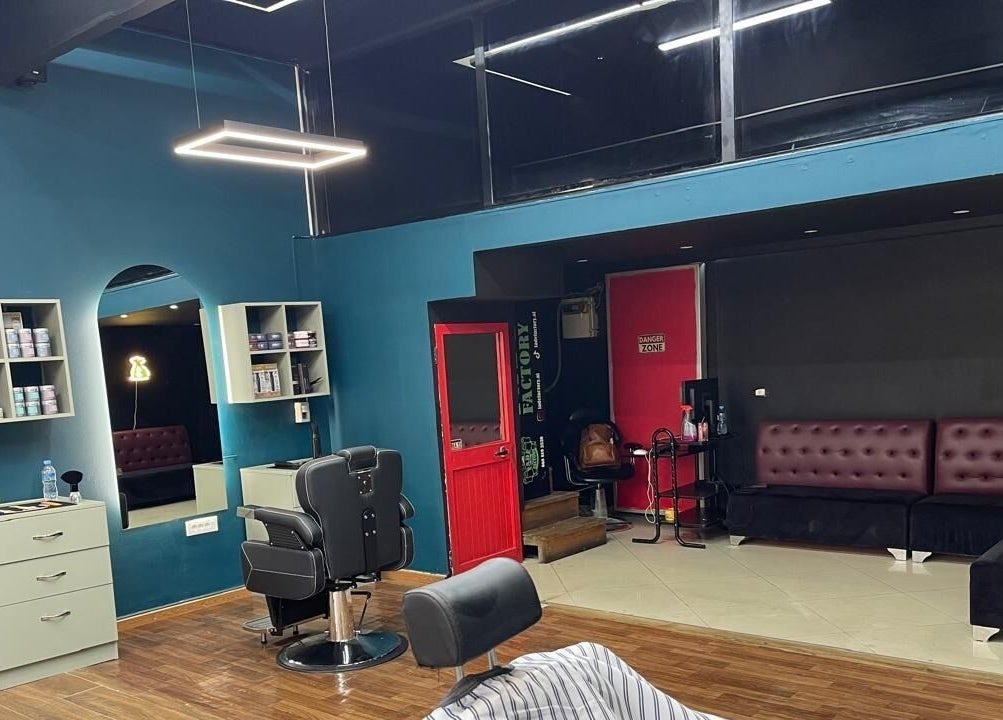 Interior of Fade Factory, Tiranë, Tirana County, AL, showcasing modern salon design and seating area.