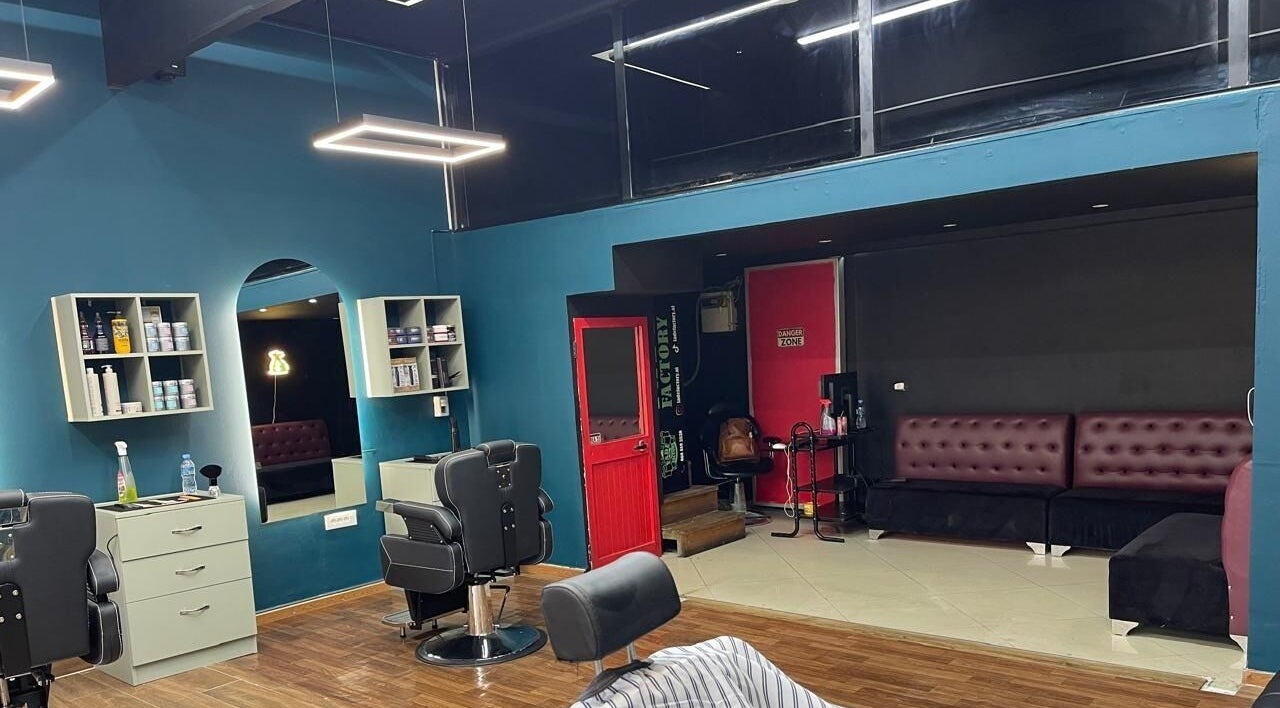 Interior of Fade Factory, Tiranë, Tirana County, AL, showcasing modern salon design and seating area.