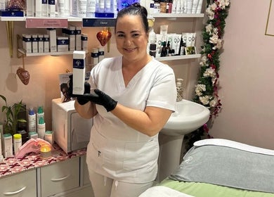 Skincare expert showcases facial product at Facials By Tina Maria in Freeport, Freeport, BS salon room.