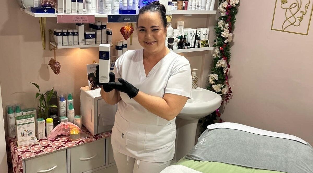 Skincare expert showcases facial product at Facials By Tina Maria in Freeport, Freeport, BS salon room.