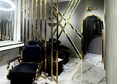 Elegant interior of Barber club Spa by Oussbarber in Dubai, Dubai, AE with golden accents and modern decor.