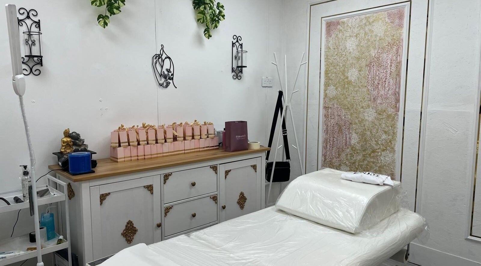 Cozy treatment room at The Aeon Aesthetics, Southall, England, GB with elegant decor and massage bed.