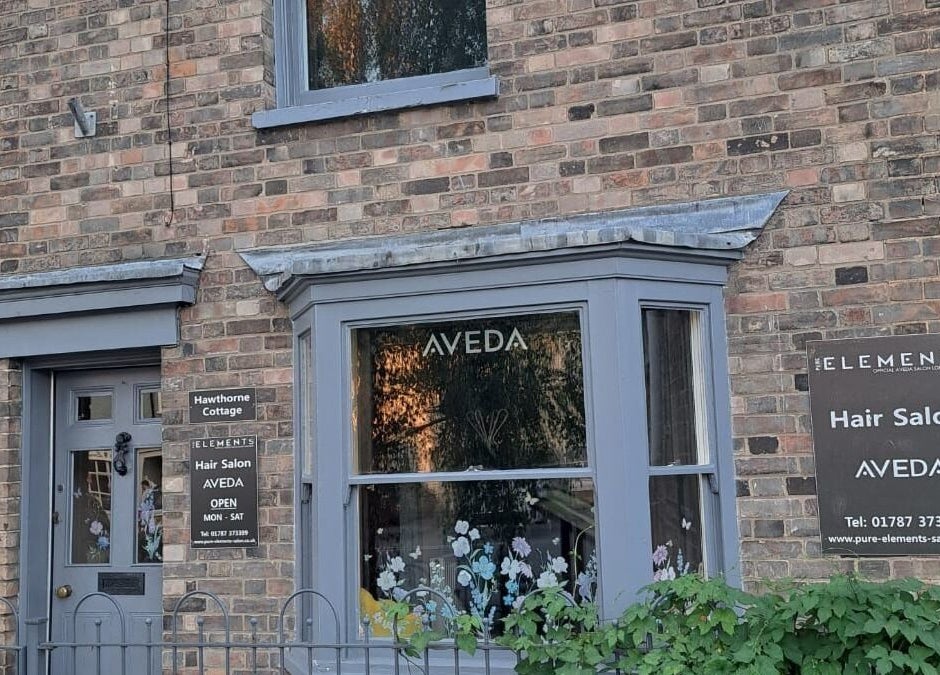 Exterior of Pure Elements hair salon in Long Melford, England, GB displaying Aveda signage.