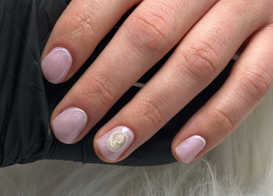 Elegant pearl-accented nails at Nail Studio 9, Kingskerswell, England, GB.