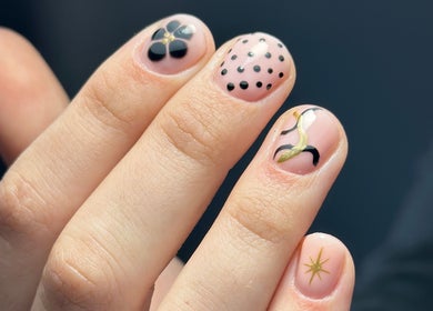 Beautiful nail art with intricate designs at Nail Studio 9, Kingskerswell, England, GB on a hand.