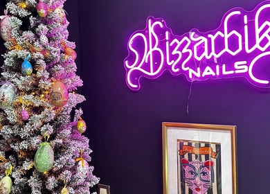 Festive decor beside Bizzarbika Nails neon sign in Zagreb, Grad Zagreb, HR, enhancing cozy vibe.