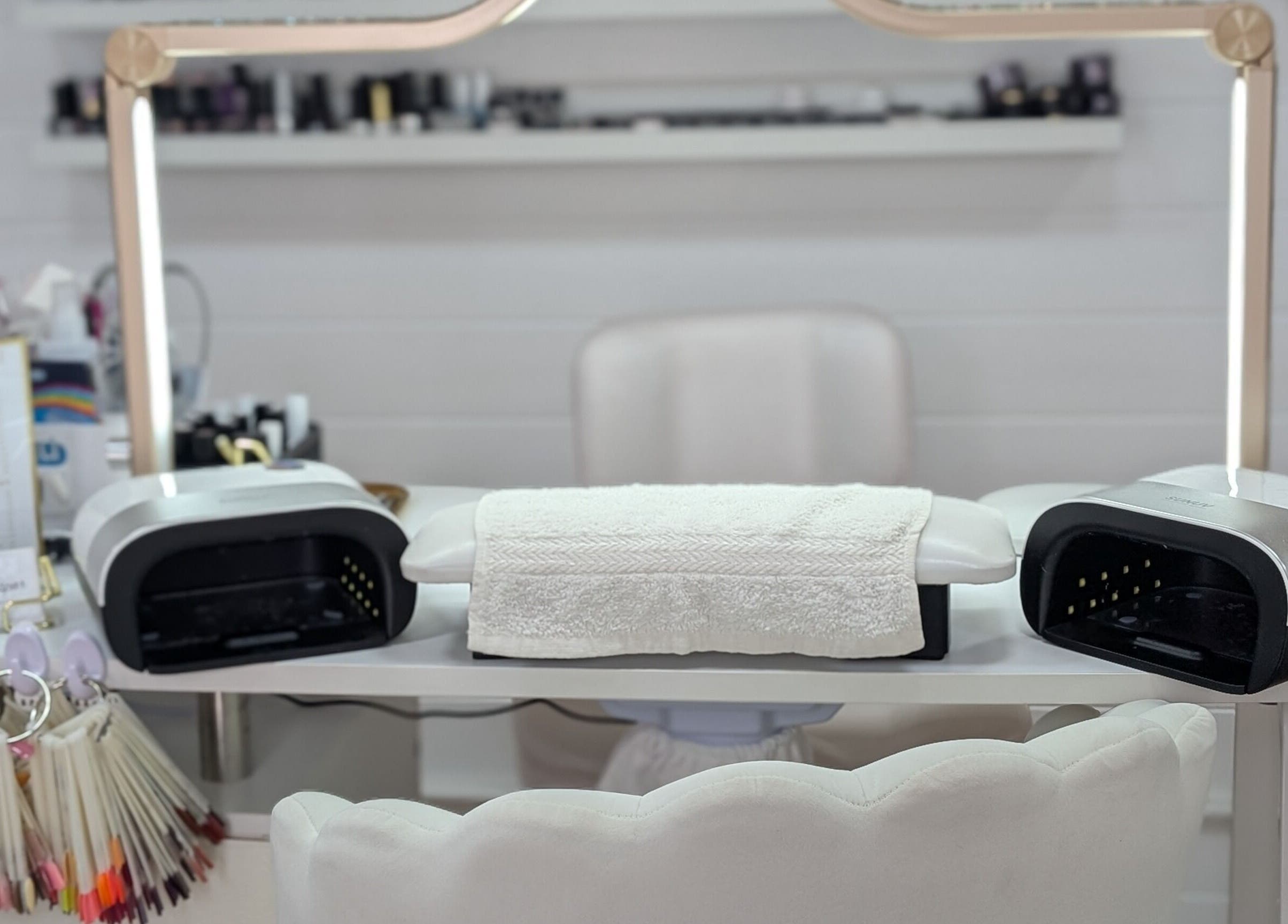 Nail workstation at Beauty by Viv, Llandudno Junction, Wales, GB, featuring modern equipment and polish samples.