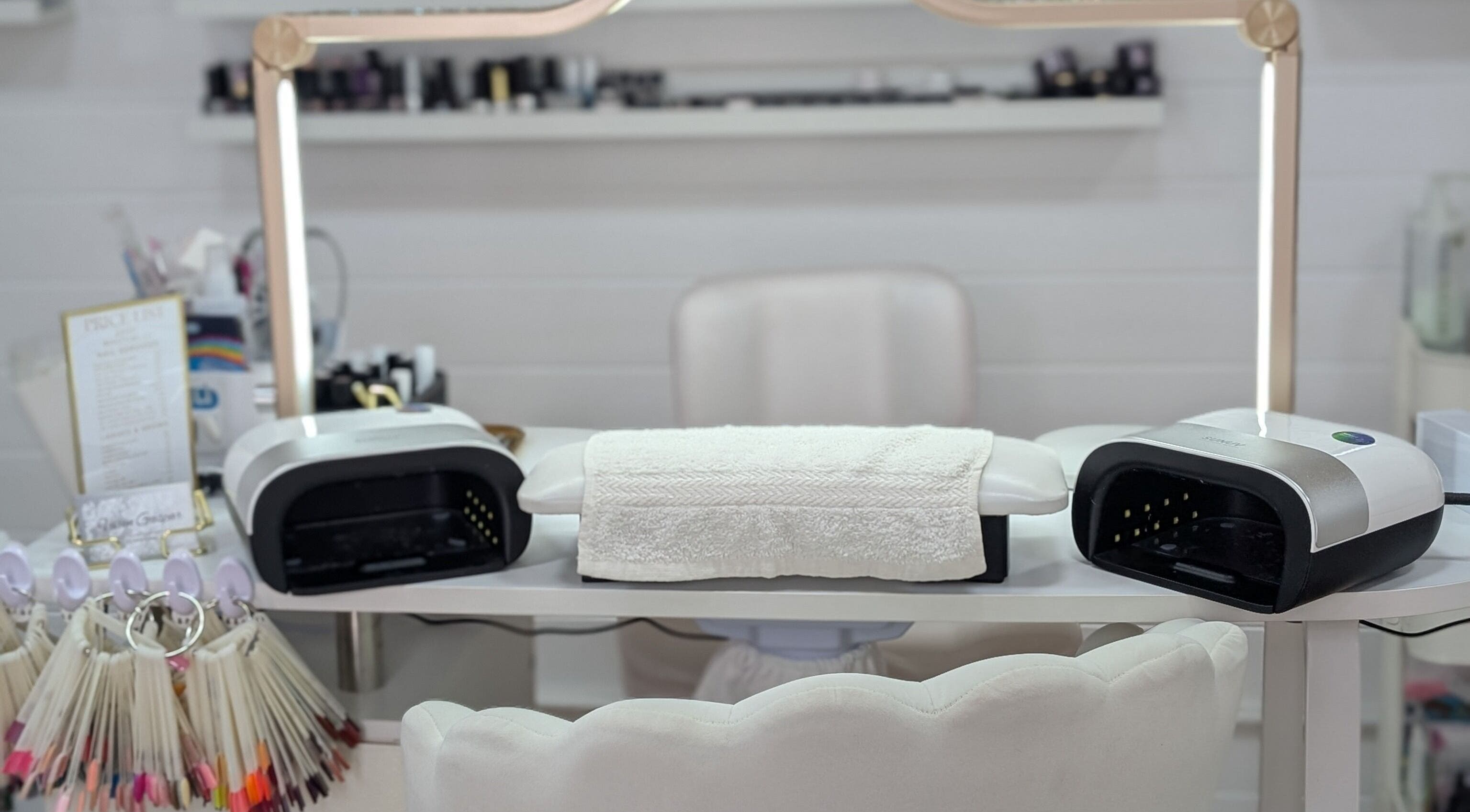 Nail workstation at Beauty by Viv, Llandudno Junction, Wales, GB, featuring modern equipment and polish samples.