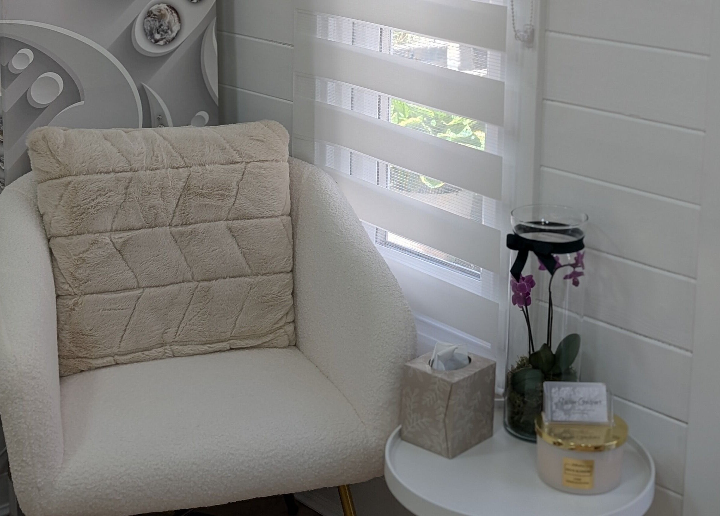 Elegant seating area at Beauty by Viv, Llandudno Junction, Wales, GB with soft chair and decorative table.
