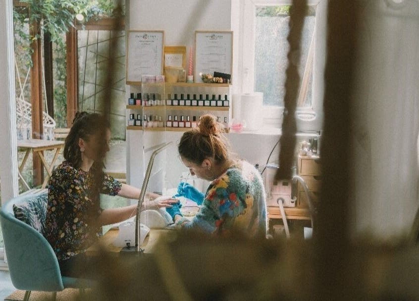 Intérieur serein de L'appartement de Nails & Colors, Pont-l'abbé, Bretagne, où une cliente reçoit une manucure.