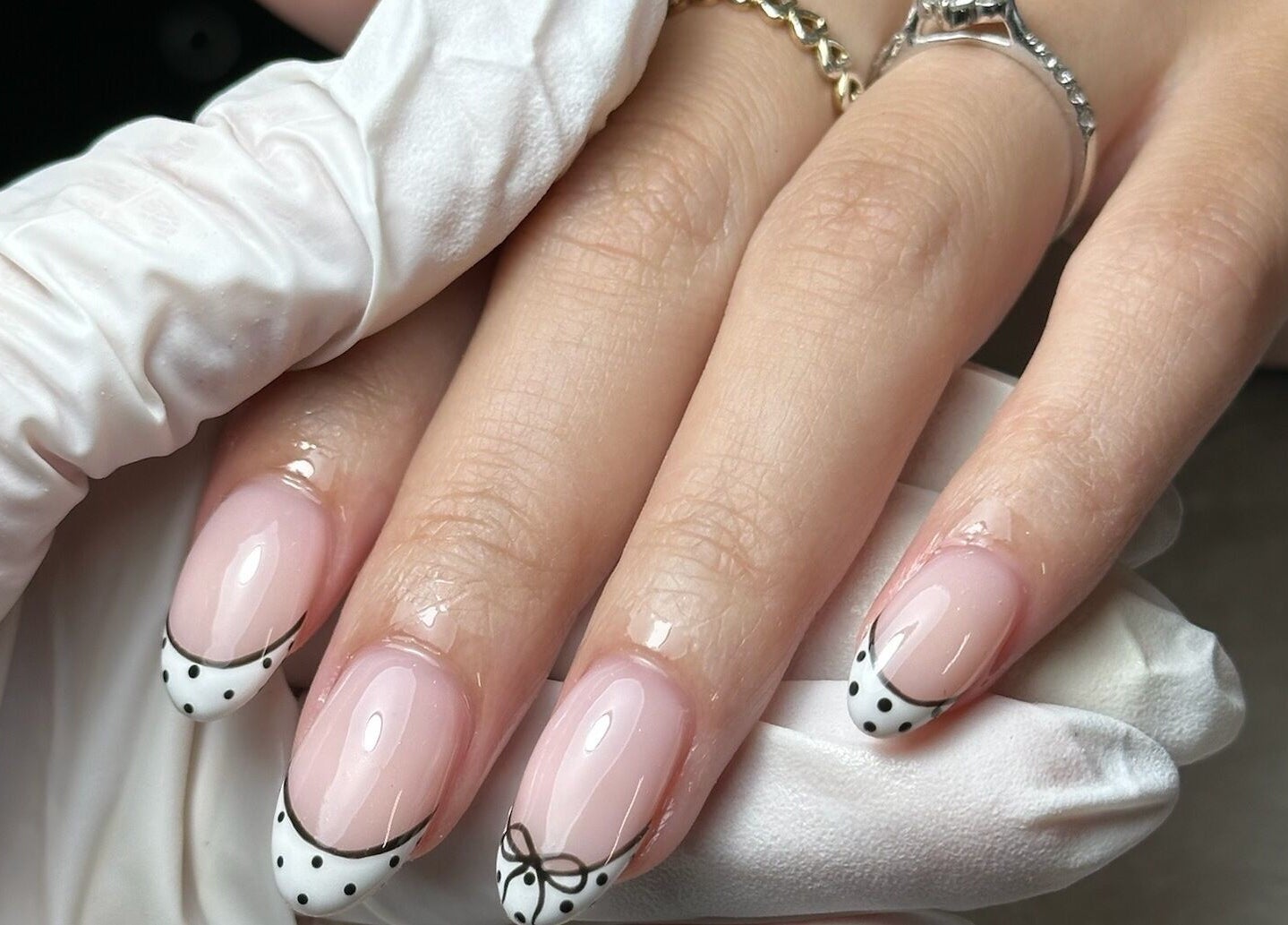 Close-up of chic nail art with bows at Onn Nails, Stockport, England, GB, showcasing detailed manicure.