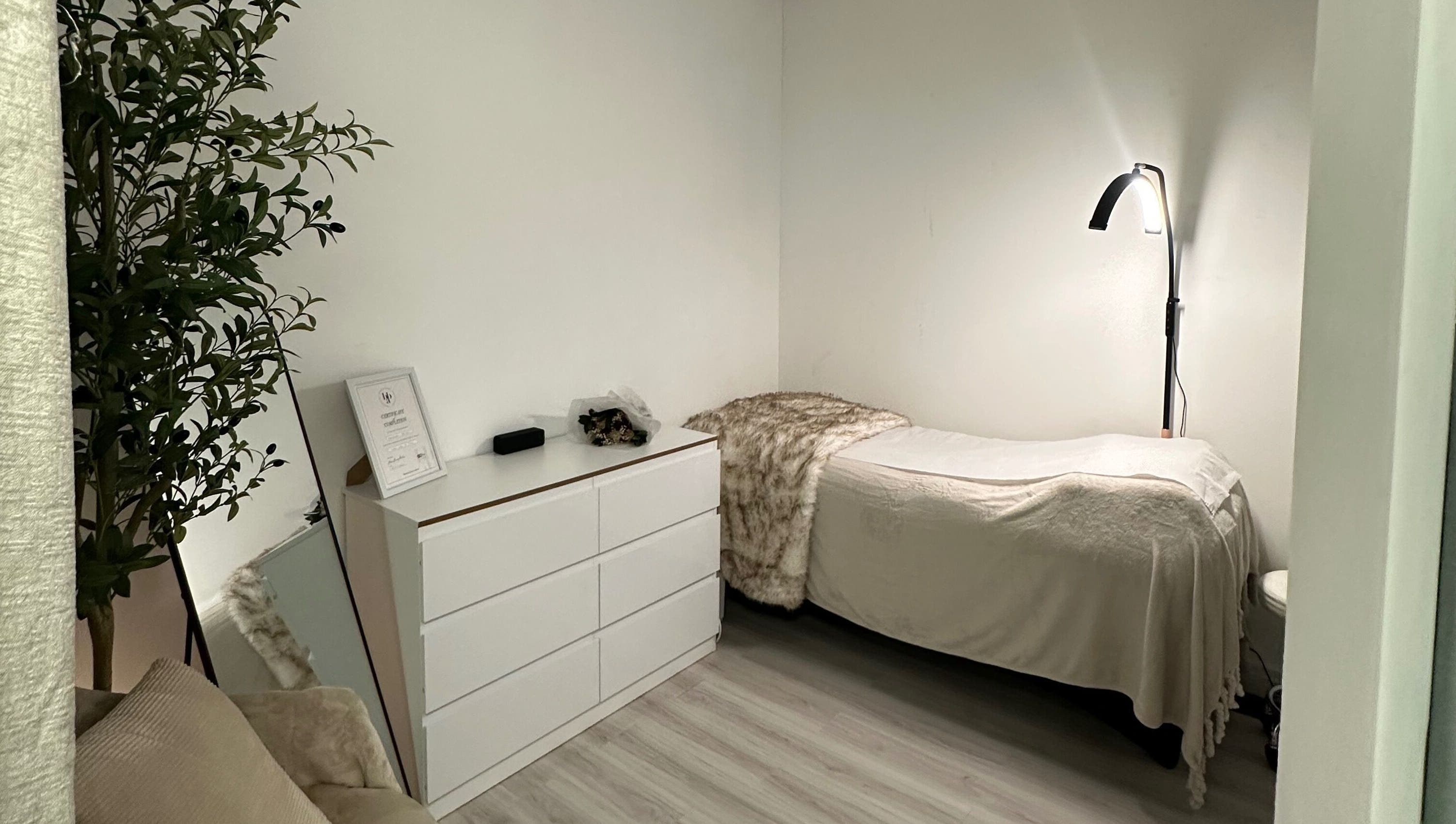 Comfortable treatment room at Browtopia & Beyond | Halal Brows in London, England, GB, featuring a soft bed and ambient lighting.