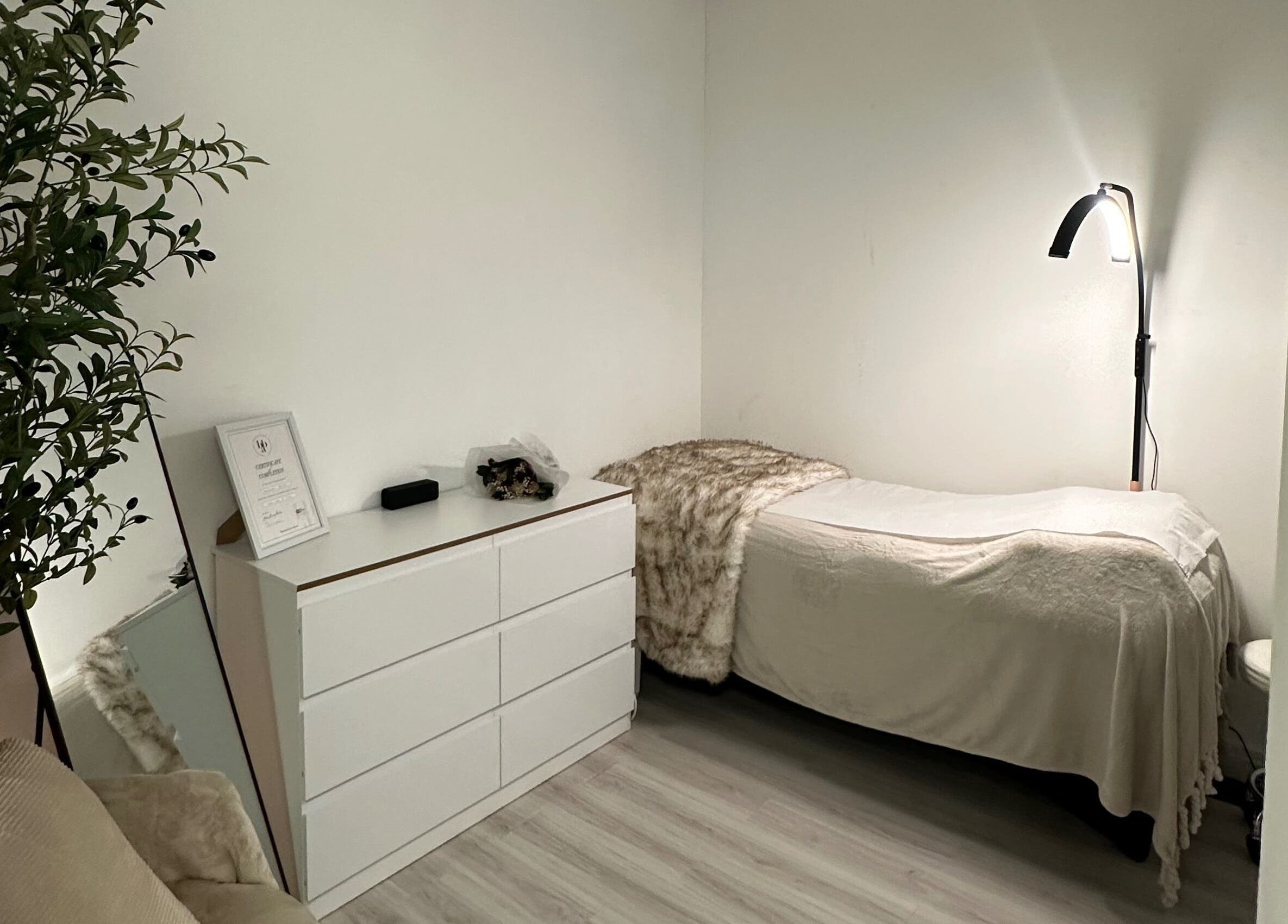 Comfortable treatment room at Browtopia & Beyond | Halal Brows in London, England, GB, featuring a soft bed and ambient lighting.