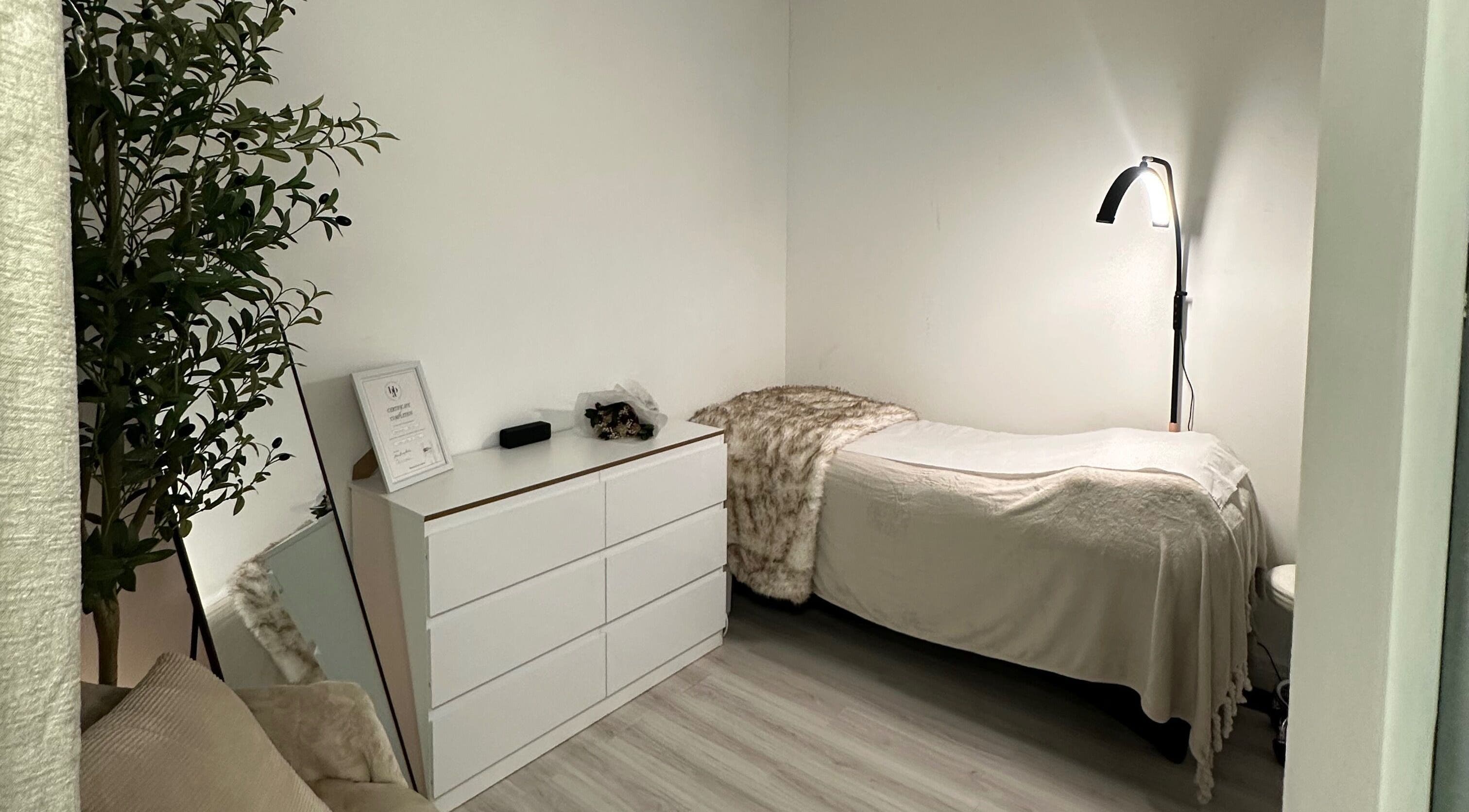 Comfortable treatment room at Browtopia & Beyond | Halal Brows in London, England, GB, featuring a soft bed and ambient lighting.