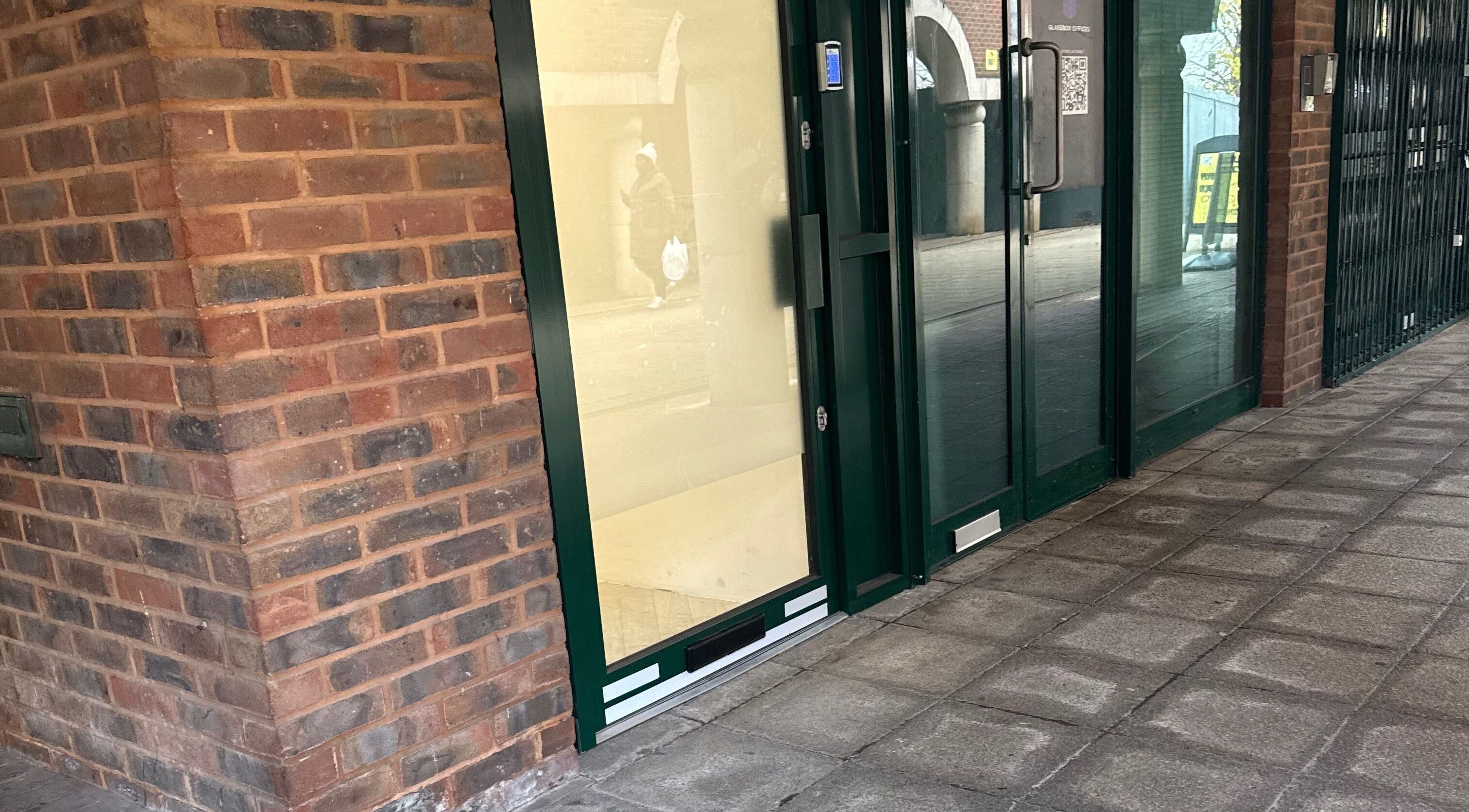 Entrance of Browtopia & Beyond | Halal Brows in London, England, GB with modern glass and brick exterior.