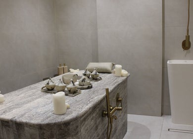 Serene massage room at Layers Spa, Riyadh, Riyadh Province, SA, featuring a stone massage table and elegant decor.