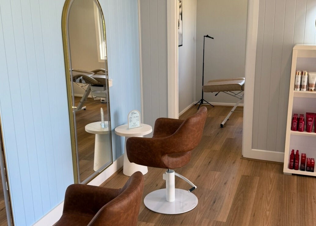 Elegant salon interior at Simone West Hair Makeup, Landsborough, Queensland, AU, featuring stylish chairs and products.