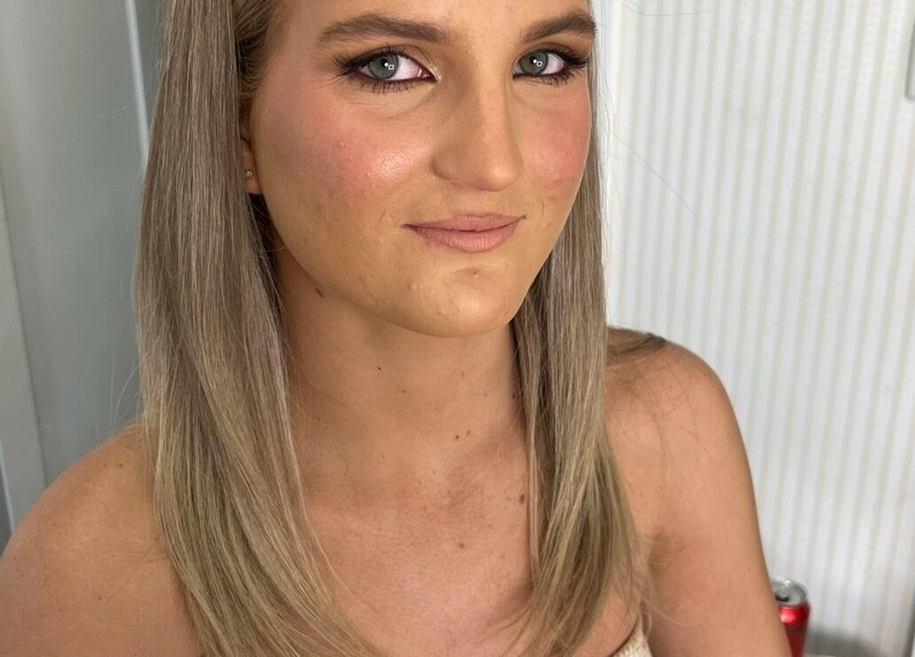 A woman showcases elegant makeup and hair styling at Simone West Hair Makeup in Landsborough, Queensland, AU.