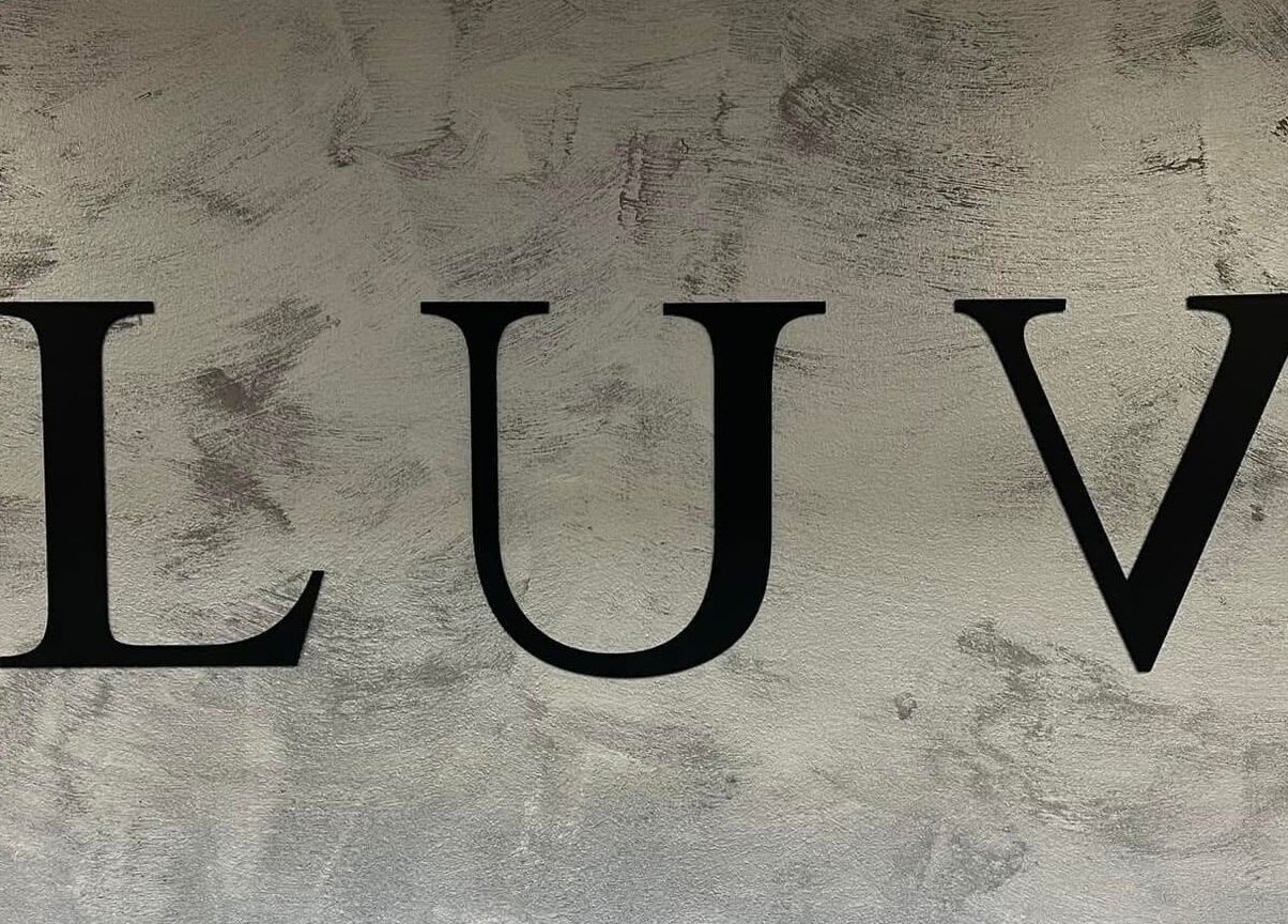 Elegant LUV sign on textured wall at Luv Ilustuudio in Audru, Pärnu Maakond, EE.