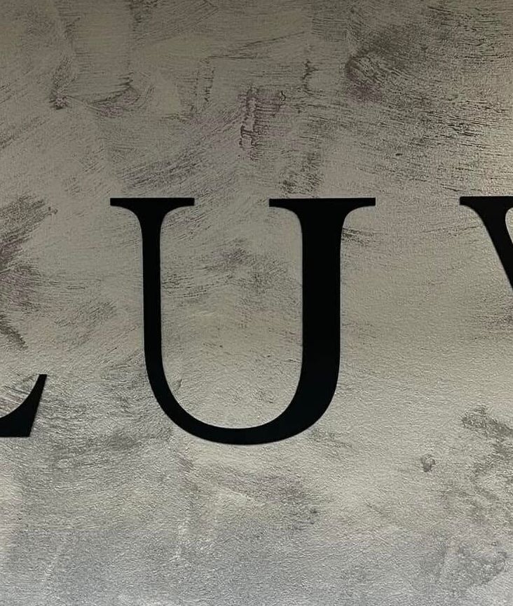 Elegant LUV sign on textured wall at Luv Ilustuudio in Audru, Pärnu Maakond, EE.