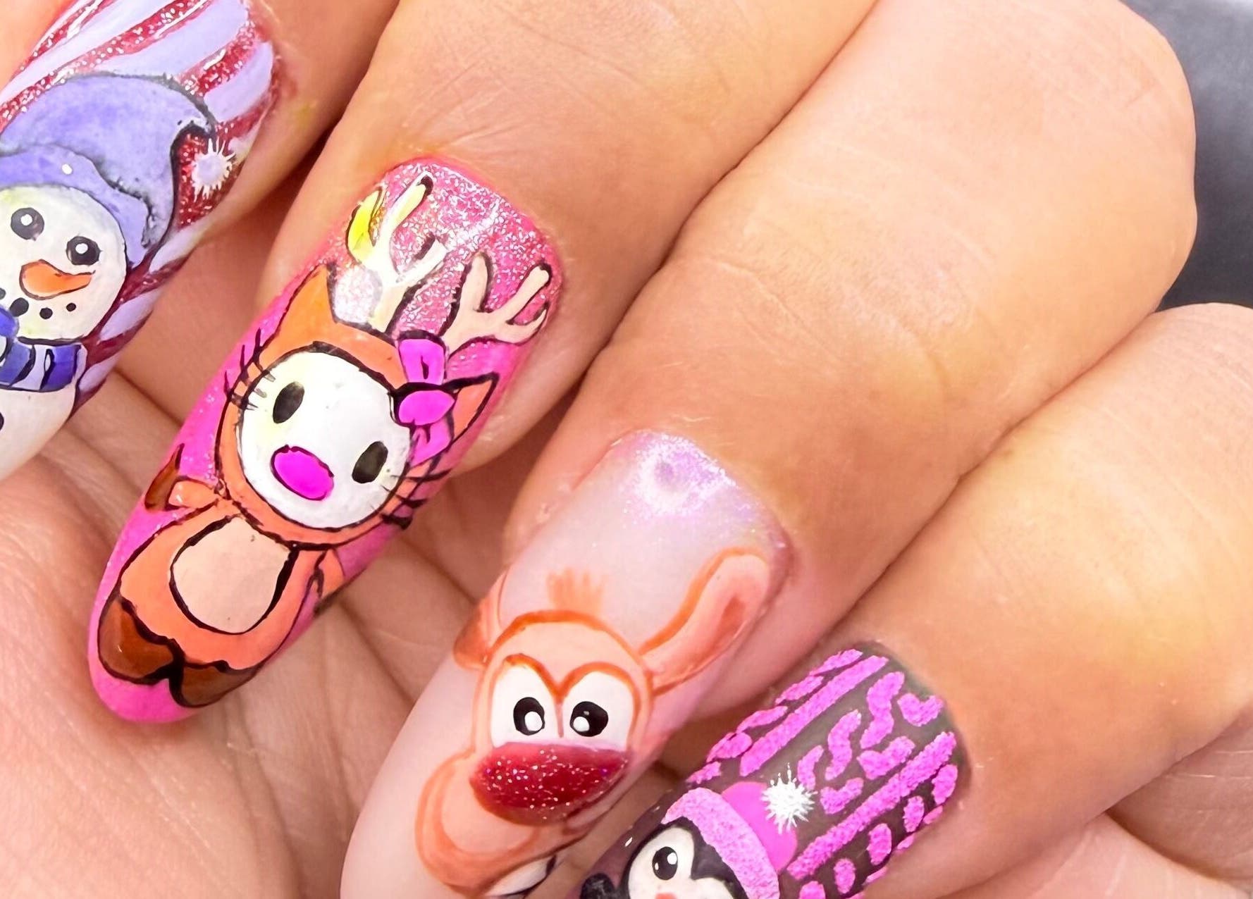 Vibrant festive nail art at Nit Sparkle Nail, Dublin, County Dublin, IE, featuring snowmen and reindeer designs.