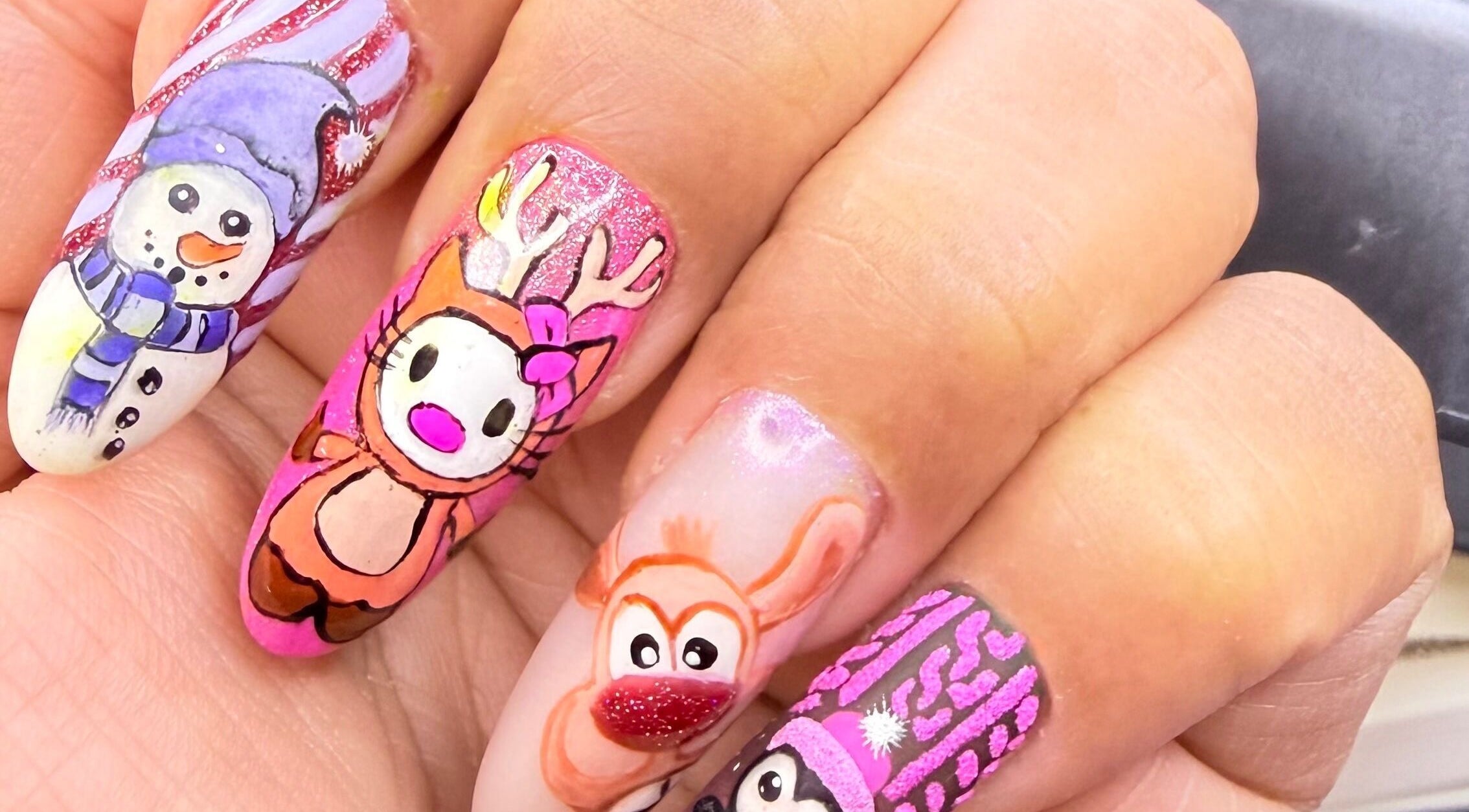 Vibrant festive nail art at Nit Sparkle Nail, Dublin, County Dublin, IE, featuring snowmen and reindeer designs.