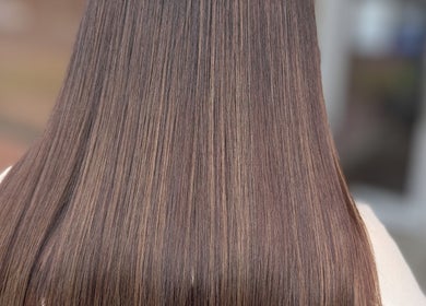 Sleek brunette hair styled at Hair By Jaimie, Melbourne, Victoria, AU, showcasing glossy, straight finish.